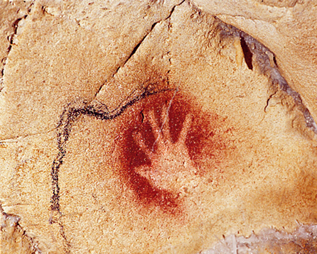 A human handprint made about 30,000 years ago, on the wall of the Chauvet-Pont-d’Arc Cave in southern France. Somebody tried to say, ‘I was here!’
